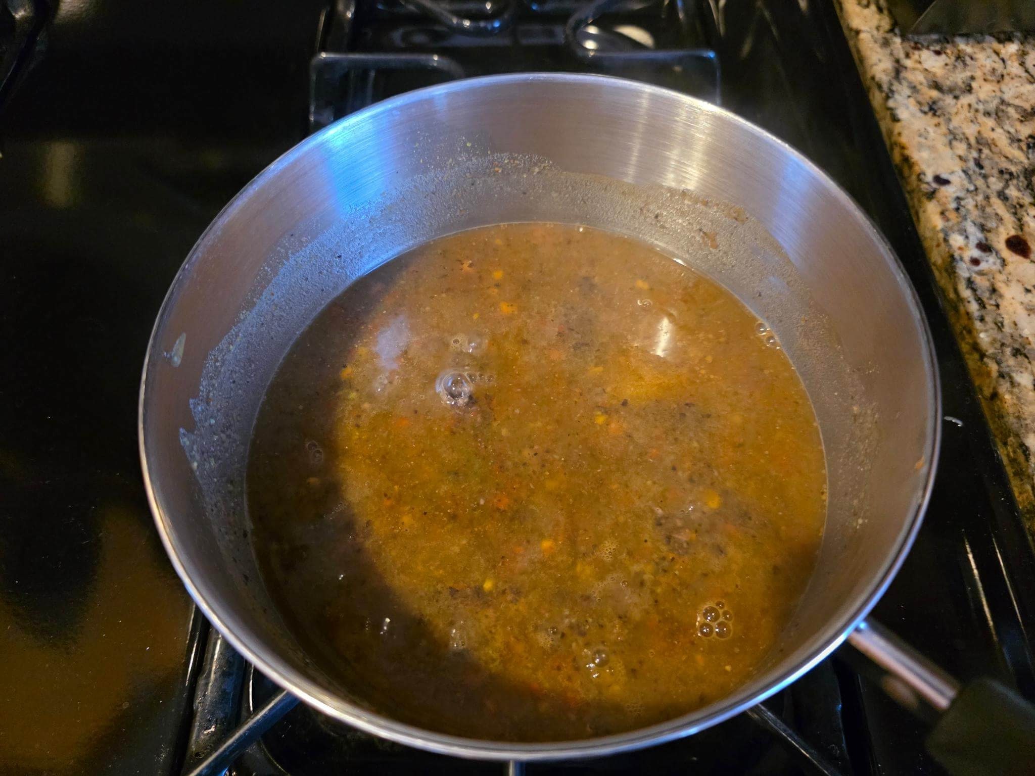Founder’s Soil Reboot Soup simmering on the stove, showing a rich blend of mushroom, bean, pepper, and FungaLight powders.